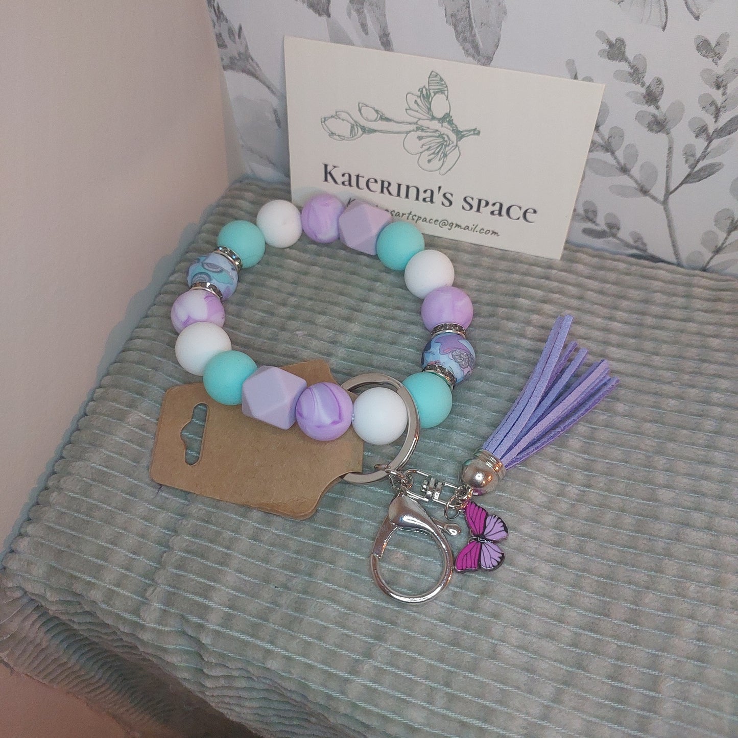 Purples, swirls and butterfly's wristlet keychain.